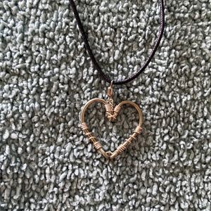 Two fish hooks made into a heart hand made